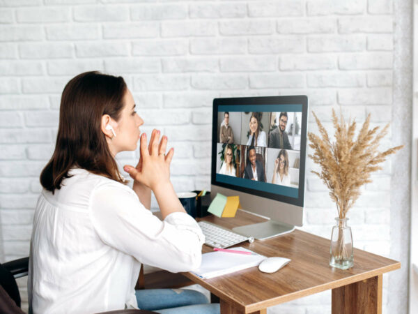Business team working from home in a video conference. 
Attractive young girl  communicates via video call online with her business colleagues about  strategy. Distant work